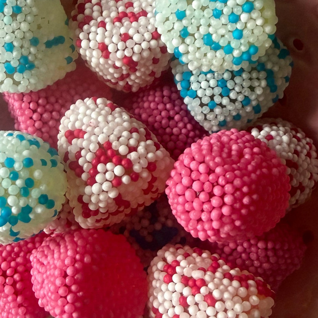 Close-up of colourful speckled berry sweets — cherry, strawberry & cream, and blueberry flavours by Grandma's Sweet Cupboard